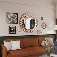 a living room with a couch, mirror and pictures on the wall above it's coffee table