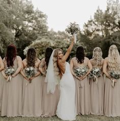 a bride and her bridal party holding their bouquets