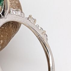 This minimalist 14K white gold setting features an earth-mined emerald with natural earth-mined diamonds. A delicate ring design perfect for an eye-catching engagement or anniversary. This ring also makes a beautiful May birthstone gift for your loved ones! The occasions to show off this ring are endless - mother's Day, graduation, wedding, birthday, date night, Christmas, etc. :) This ring is made with solid 14K Gold and naturally Earth-mined SI / G-H diamonds. Emerald Ring With Prong Setting For Promise, Diamond White Emerald Ring With Prong Setting For Promise, Brilliant Cut Moissanite Emerald Ring For Promise, Platinum Emerald Ring With Prong Setting For Promise, Platinum Emerald Promise Ring, Platinum Round Emerald Promise Ring, Diamond Ring With Prong Setting For May Birthstone, Emerald Promise Ring With Brilliant Cut, Diamond White Brilliant Cut Emerald Promise Ring