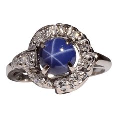 This is part of Chairish’s Fine Jewelry assortment.  Estate synthetic star sapphire & diamond ring. This 14 karat white gold ring features a synthetic star sapphire accented with 10 single cut diamonds at .16 carat total weight. The diamonds have VS2 clarity and G-I color. This estate ring is a size 5.5. [SJ 9268 P]  Metal: 14k Gold,White Gold  Stone: Diamond,Star Sapphire  Stone Cut: Round Cut Star-shaped Gemstone Rings For Formal Occasions, Star Sapphire Stone, Vintage Platinum Rings, 1 Carat Diamond Ring, Estate Ring, Diamond Wedding Sets, Star Sapphire, Sapphire Diamond Ring, Diamond Star