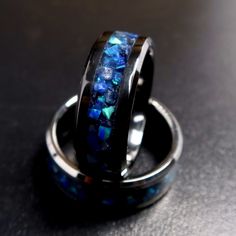 "This is the Sapphire Storm Ring, made with Sapphire and Cobalt Blue Opal on a black blue background. Meant to be the counter to the Lava Rock Ring, everything is the opposite from the colors to the glow being blue. The Sapphire adds depth to the ring while the Opal takes center stage with its different blue/green hues and flashes The ring will come in your choice of either a Tungsten-Carbide or Black Ceramic (titanium carbide) band. Both bands are extremely durable and scratch resistant, being Glow In The Dark Wedding, Black And Blue Background, Rock Ring, Wedding Band For Men, Rock Rings, Opal Engagement Ring, Dark Wedding, Opal Engagement, Engagement Rings Opal