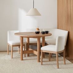 a table with two chairs next to it and a lamp hanging from the ceiling above