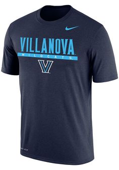 Show off your team pride in this Villanova Wildcats Navy Blue Dri-FIT Flat Name Mascot Short Sleeve T Shirt! This Villanova Short Sleeve Tee features a screen print of Villanova Wildcats with team logo below. Make sure everyone knows you root for the Wildcats with this Navy Blue Villanova T Shirt. Go Wildcats! Dri-FIT moisture-wicking technology, Crew neckline, Rib-knit collar, cuffs, and hem, Unisex, Screen printed team graphic on chest, Iconic Nike swoosh below neckline, 57% COTTON / 43% POL Blue Fan Apparel Tops For Game Day, Blue Tops With Team Logo For Game Day, Blue Sports Fan Tops For Fan Gear, Blue Tops For College Sports Season, Blue Team Spirit Tops For Fan Gear, Blue Sports Fan Tops For College, Blue School Spirit Tops For College, Blue Tops For Team Spirit, Blue College Tops With School Spirit