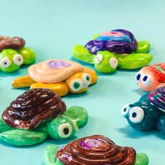 there are many small plastic turtle toys on the table