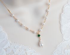 Vintage, Romantic Style Emerald Necklace, Wedding Pearl and Emerald CZ Bridal Choker, Emerald CZ Vintage Swarovski Pearl Necklace  Materials used: - White/Ivory Cream Swarovski pearls - cubic zirconia stones - gold plated over brass The necklace will arrive packaged ready for gift giving in a delicate white jewelry box with a silver ribbon. Matching earrings for this necklace:  Back to my shop http://www.etsy.com/shop/crinadesign73 Thank you for visiting my store! Black Spinel Necklace, Purple Amethyst Earrings, Swarovski Pearl Necklace, Custom Initial Necklace, Bridal Choker, Silver Ribbon, Surfer Necklace, White Jewelry Box, Pearl Choker Necklace