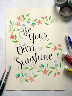 a card with the words be your own sunshine surrounded by markers and paintbrushes