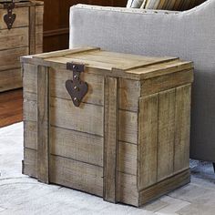 a wooden trunk sitting on top of a white rug