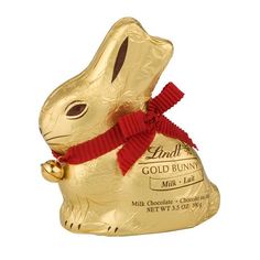 a gold bunny shaped chocolate bar with a red ribbon around it's neck, on a white background