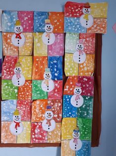 the colorful paper squares have snowmen on them