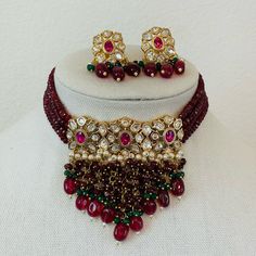 Gold Finish Ruby Red and Emerald Green Beads Kundan Choker Set with Pearls, Mona Lisa Beads, and Stones Festive Beaded Choker With Round Beads, Festival Celebration Beaded Choker, Festive Beaded Choker For Celebrations, Red Ruby Beaded Necklaces With Polished Beads, Red Faceted Beads For Festivals, Red Ruby Beaded Necklace With Polished Beads, Festive Beaded Temple Jewelry Choker, Festive Ruby Beaded Necklaces, Red Bridal Necklace With Faceted Round Beads