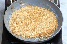 a frying pan filled with food sitting on top of an electric stove burner