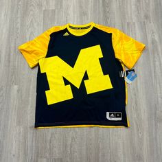 Nwt Vintage Adidas Michigan Wolverines Shirt Mens Extra Large Y2k All Over Print Condition: New. Please Refer To The Measurements And Photos. Measurements (Pit To Pit X Length [Shoulder To Bottom Hem] : 24in X 30in Yellow Sports T-shirt With Logo Print, Sporty Yellow T-shirt For Fan Merchandise, Casual Adidas Tops For Fans, Casual Adidas Tops For Fan Merchandise, Sporty Yellow Shirt For Sports, Yellow Sporty Shirt For Sports, Yellow Short Sleeve T-shirt For Team Spirit, Yellow School Spirit Graphic Print Top, Yellow Logo Print Top For Fans