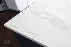 a white marble counter top in a kitchen