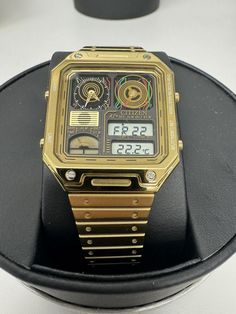 This stylish Citizen watch features a gold-toned bracelet and square-shaped multicolor case, with a black analog and digital display. The watch is equipped with a perpetual calendar and chronograph features. It has a case size of 33mm, case thickness of 9mm and a lug width of 15mm, making it the perfect dress/formal watch for men. The Citizen Star Wars C-3PO JG2123-59E wristwatch is water-resistant up to 50 meters and has a fixed bezel type. The watch comes with its original box/packaging, but without papers or manuals. It has a deployant closure and can fit a maximum wrist size of 7.26-7.5 inches. The watch is from the 2010-now collection and is not vintage. This timepiece is perfect for any Star Wars fan and is sure to make a great addition to any collection. WATCH WAS STORE DISPLAY WITH Retro Gold Watches With Subdials, Gold Retro Watches With Subdials, Retro Watch Accessories With Rectangular Analog Dial, Retro Watch Accessories With Analog Display And Rectangular Dial, Retro Watch Accessories With Analog Display, Formal Watch, Citizen Watch, Perpetual Calendar, Watch For Men