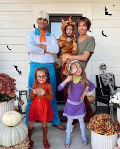 three adults and two children dressed up in costumes