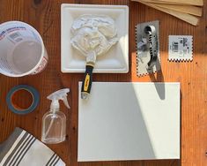 the supplies needed for painting are laid out on top of a wooden table with scissors, glue, and other items