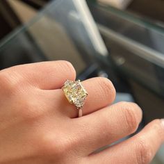 a close up of a person's hand with a ring on it