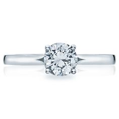 a white gold engagement ring with a round diamond