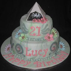 a birthday cake decorated with flowers and the number 21