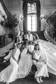 a group of women sitting next to each other on top of stairs