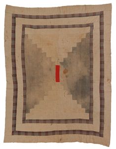 an old piece of cloth with a red square in the center on top of it