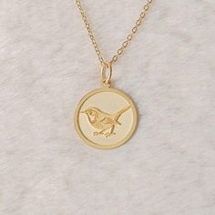 Gold Wren Bird Pendant - Bird Gold Necklace ● Material of pendant: Solid Gold 14k ( REAL GOLD ) ● Metal Stamp: 14k ( REAL GOLD ) ● The pendant is available in 5 sizes: - 12,7 mm / 0.5 inches (Diameter) - 14,0 mm / 0,55 inches ( Diameter ) In the photos - 15,3 mm / 0.6 inches ( Diameter ) - 16,5 mm / 0,65 inches ( Diameter ) - 19,1 mm / 0,75 inches ( Diameter ) ( In the photos the size is 14mm / 0.55 inches Diameter ) ( Jump Ring inner diameter: 4 mm ) ● Material of chain: Solid gold 14k ( REAL G Necklace With Round Pendant And Bird Design For Gifts, Round Pendant Necklace With Bird Design For Gift, Bird Design Round Pendant Jewelry As Gift, Bird Design Round Pendant Jewelry For Gifts, Bird Design Round Pendant Jewelry Gift, Gift Jewelry With Bird Design Round Pendant, Round Pendant Jewelry With Bird Design For Gift, Bird Design Necklace Gift, Round Necklace With Bird Design For Gift