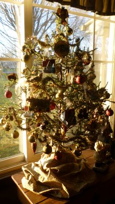 a small christmas tree in front of a window