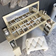 a mirrored vanity table with drawers and stool