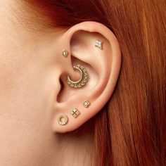 a woman with red hair wearing ear piercings