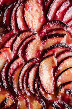 sliced plums on top of each other with powdered sugar and icing over them