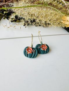 These fun hoop earrings have been handmade with polymer clay. All floral detail work is completely done by hand giving each pair a unique look! These are truly one of a kind! You can choose from gold plated stainless steel, antiqued brass or regular stainless steel hoops. All hoops are nickel free, making these great for sensitive ears. The hoops are about 1 inch in diameter. The clay pumpkins are about 1 inch in width. The total length of the earrings is about 1.5 inches. These earrings are super lightweight and so comfortable to wear! Very cute for fall and Halloween! Be sure to check out our shop for more colors! www.etsy.com/shop/theglassbird Also come like our facebook page to receive updates on new items, coupon codes and future giveaways! https://www.facebook.com/TheGlassBird Thanks Gold Whimsical Polymer Clay Earrings, Whimsical Gold Polymer Clay Earrings, Whimsical Handmade Clay Earrings, Handmade Green Flower Earrings For Everyday, Handmade Green Clay Jewelry, Everyday Handmade Green Flower Earrings, Handmade Polymer Clay Dangle Hoop Earrings, Handmade Flower Dangle Earrings In Polymer Clay, Handmade Polymer Clay Hoop Earrings