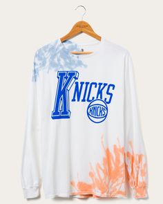 NY Knicks Tie Dye Long Sleeve Tee | Junk Food Clothing – Junk Food Clothing Throwback Long Sleeve T-shirt For Sports Events, Streetwear Cotton Tops With Paint Splatter, Cotton Paint Splatter Tops For Streetwear, Tie Dye Letter Print Tops For Streetwear, Throwback Long Sleeve Letter Print T-shirt, White Paint Splatter Tops For Streetwear, White Long Sleeve Throwback T-shirt, Sporty Tie-dye Cotton T-shirt, Paint Splattered Cotton Crew Neck Tops