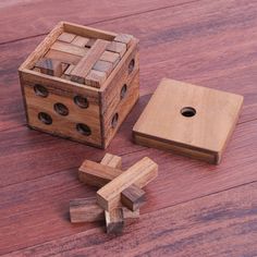 a wooden block with holes in the middle next to it and a piece of wood that has been cut into smaller pieces