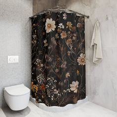 a bathroom with a toilet, shower curtain and tiled walls in the same color scheme