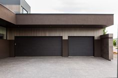 two garage doors are open in front of a building