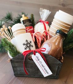 a wooden crate filled with hot chocolates, marshmallows and candy canes