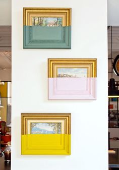 three different colored frames hanging on the wall