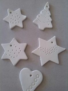 four white ceramic stars and a heart ornament