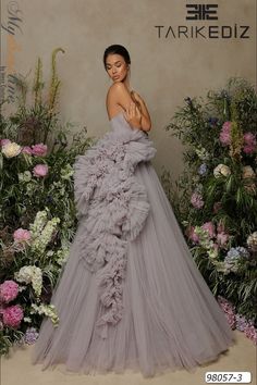 Looking for a breathtaking dress for your next big event? Check out the Tarik Ediz 98057 from the Spring 2022 evening collection. This gorgeous tulle gown is sure to make you stand out from the crowd. Whether you're attending a gala, wedding, or prom, this dress will have you feeling like a true celebrity on the red carpet. Tulle Dress Couture Candy, High Fashion Gowns, Ruffle Tulle Dress, Gown Couture, Tulle Ruffles, Long Fitted Dresses, Lilac Blue, Tarik Ediz, Trumpet Gown