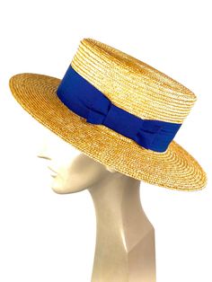 Straw boater hat made with 8/9 millimeters natural straw braid. Embellished with a 50 millimeters wide blue grosgrain ribbon. You can choose the grosgrain ribbon in the color you like best - (in this ad the grosgrain is azure) Measurements in centimeters are 34 x 32. Crown height 9. Brim length 7. These measurements may have some slight variation depending on the size of the hat. For its elaboration we only use very good quality and resistant straw braids. In our workshop in the Pyrenees we sew Summer Boater Hat For Garden Party With Flat Brim, Handmade Straw Hat For Summer Garden Party, Handmade Straw Hat For Garden Party In Summer, Brimmed Toquilla Straw Boater Hat For Kentucky Derby, Natural Straw Boater Hat For Kentucky Derby, Summer Boater Hat With Short Brim For Kentucky Derby, Fitted Toquilla Straw Hat Bands For Summer, Summer Boater Hat For Kentucky Derby With Short Brim, Handmade Flat Crown Hats For Summer