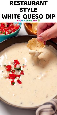 a hand dipping a tortilla chip into a bowl of quesadilla dip