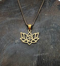 HANDMADE Beautiful dainty Lotus flower with Om symbol, sacred geometry pendant. The Om represents the whole Universe. It symbolise the unity of all things, that all things are one. The lotus is the symbol of what is divine or immortality in humanity, and is also a symbol of divine perfection. A symbol of purity, enlightenment, self-regeneration and rebirth. The attribute of sun and fire gods. It symbolizes the realization of inner potential and in Tantric and Yogic traditions the lotus symbolize Adjustable Spiritual Necklace With Flower Charm, Symbolic Bronze Locket Necklace, Spiritual Oxidized Flower Pendant Jewelry, Spiritual Engraved Flower Pendant Jewelry, Spiritual Brass Jewelry With Oxidized Finish, Spiritual Engraved Flower Pendant Necklace, Oxidized Pendant For Meditation, Oxidized Finish Pendant For Meditation, Spiritual Jewelry With Flower Charm Pendant