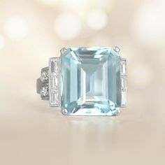 This stunning aquamarine ring showcases a magnificent approx 10.55-carat emerald cut aquamarine, held securely by the prongs. On both sides of the center stone, there are baguette-cut diamonds . The curved shoulders of the ring have old mine-cut diamonds, totaling approximately 1.20 carats. Handcrafted, the ring is made of platinum and features an intricate geometric design. ✦ GEMSTONE SPECIFICATIONS:    Aquamarine Weight: Approx 10.55 Carats  Aquamarine Cut: Emerald Cut  Total Diamond Weight: A Estate Diamond Jewelry, Aquamarine Ring, Baguette Cut Diamond, Engagement Ring Cuts, Aquamarine Rings, Platinum Ring, Baguette Cut, Jewelry Cleaner, Amethyst Ring