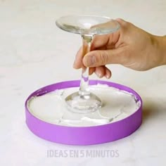 a person is holding a wine glass in the middle of a tray with white substance on it