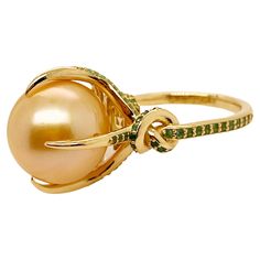 Glamorously bold and unabashedly seductive. This showstopper ring features a Golden Australian South Sea pearl poised between sharp eagle style talons and embraced by powerful Emerald encrusted knotted ropes. Handcrafted in 18ct yellow gold High quality 14mm Australian Golden South Sea Pearl Golden Pearl and Emeralds Ethically sourced gold Over a hundred Emeralds Ready to ship size 8 US/ P UK AUD *can be resized at request Ready to ship ABOUT THE BRAND Once shrouded in mystery, the story of Ohliguer emerged from the not-too-distant past. A great grandmother married to the last Tsars cousin, presented to King George V, King Edward VII, Queen Mary and Queen Alexandra and regularly dined with the infamous Rasputin. Her father supplied jewels the size of reptilian eggs from his mines in the Ur Queen Alexandra, Vintage Tiffany, Golden South Sea Pearls, Sea Pearls, South Seas, South Sea Pearls, Queen Mary, Emerald Engagement Ring, Emerald Jewelry