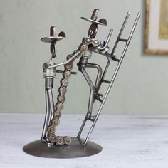 a metal sculpture with multiple pieces of art on it