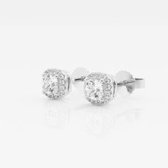 Soft cushion shaped lab grown diamonds are encompassed with smaller scintillating round diamonds in this halo styled stud earring pair. Whether you plan to wear it to work or to a brunch party with friends, these are sure to be attention-grabbers. White Round Cut Halo Cluster Earrings, Dazzling White Diamond Earrings With Halo Design, White Diamond Cluster Earrings With Halo Design, Dazzling White Diamond Halo Earrings, Dazzling White Halo Diamond Earrings, White Diamond Halo Earrings In Fine Jewelry Style, White Gold Halo Lab Grown Diamond Earrings, White Diamond Halo Earrings Fine Jewelry, Lab Grown Diamond Halo Earrings For Gift