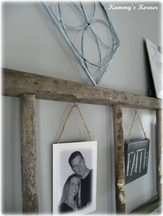 two framed pictures hang on a wooden shelf above a couple's initials and name