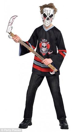 a young boy wearing a hockey jersey and mask holding an ice hockey stick in his hands