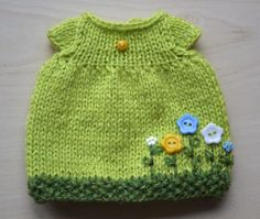 a green knitted hat with flowers on it